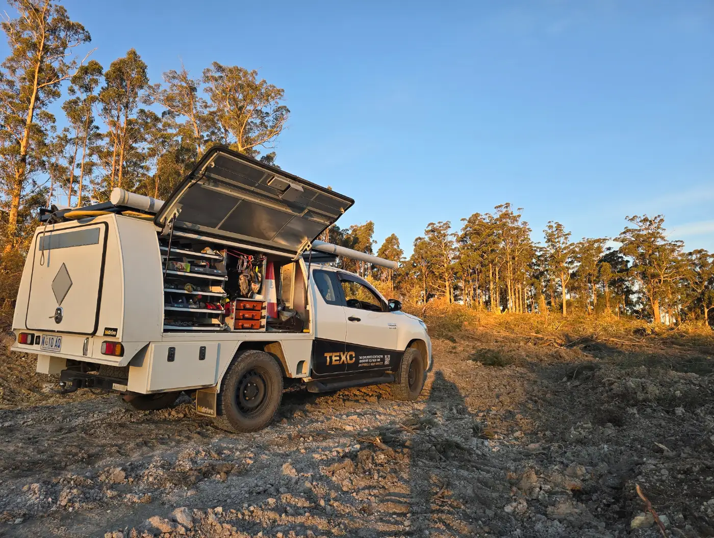 TEXC service vehicle with its canopy open on a Tasmanian forestry site at last light